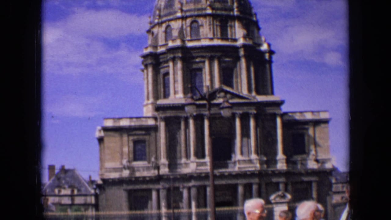 Domed stone building fills the frame with men partly visible below.