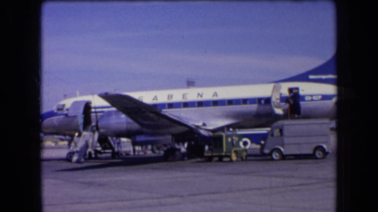 1963 France footage showing a Sabena airliner on the airport apron with stairs deployed and ground activity nearby.