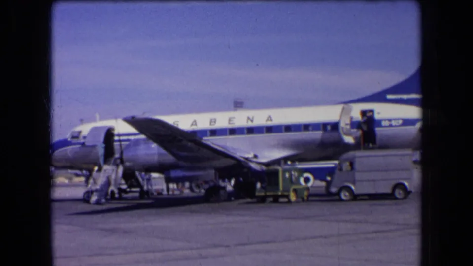 1963 France footage showing a Sabena airliner on the airport apron with stairs deployed and ground activity nearby.