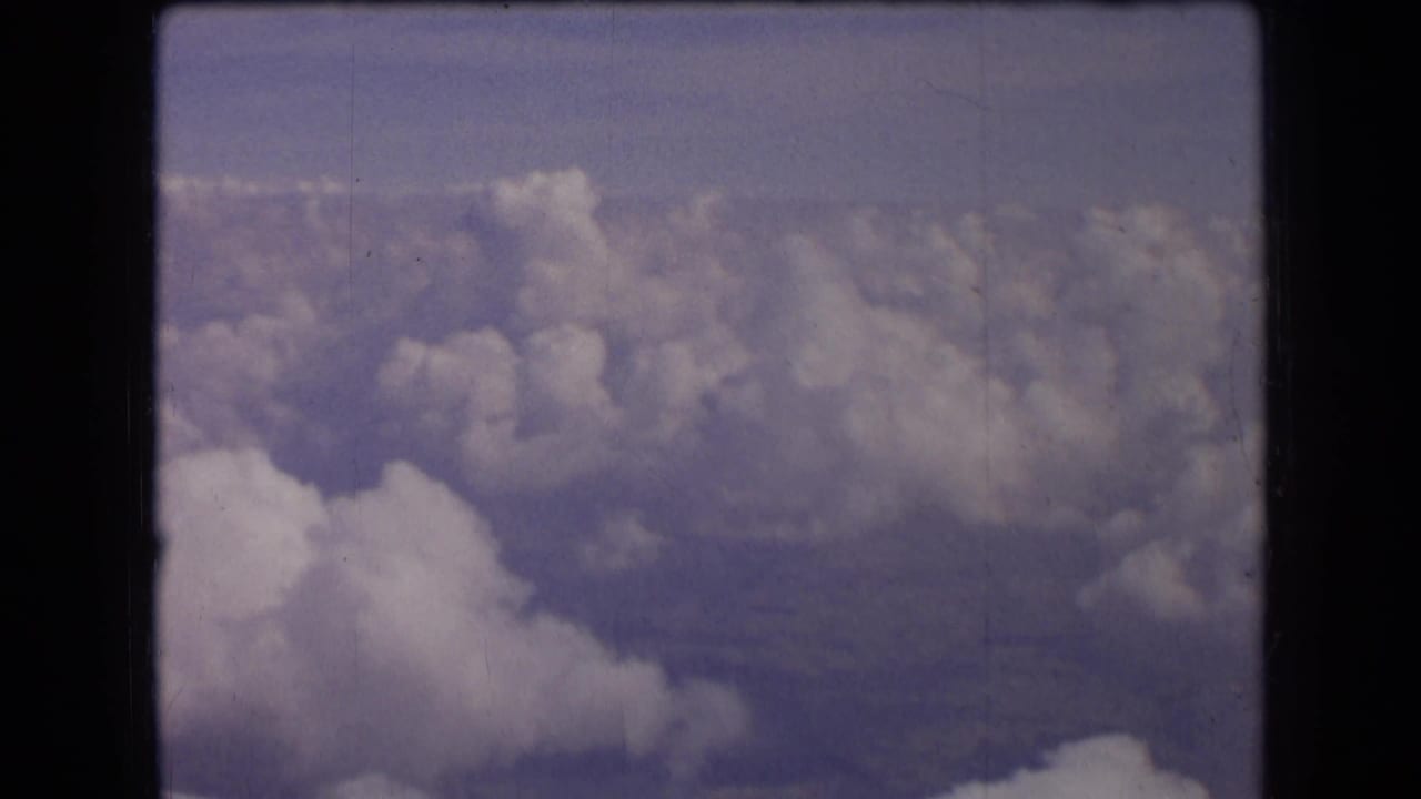 Wide cloud layer with faint ground visible through haze.