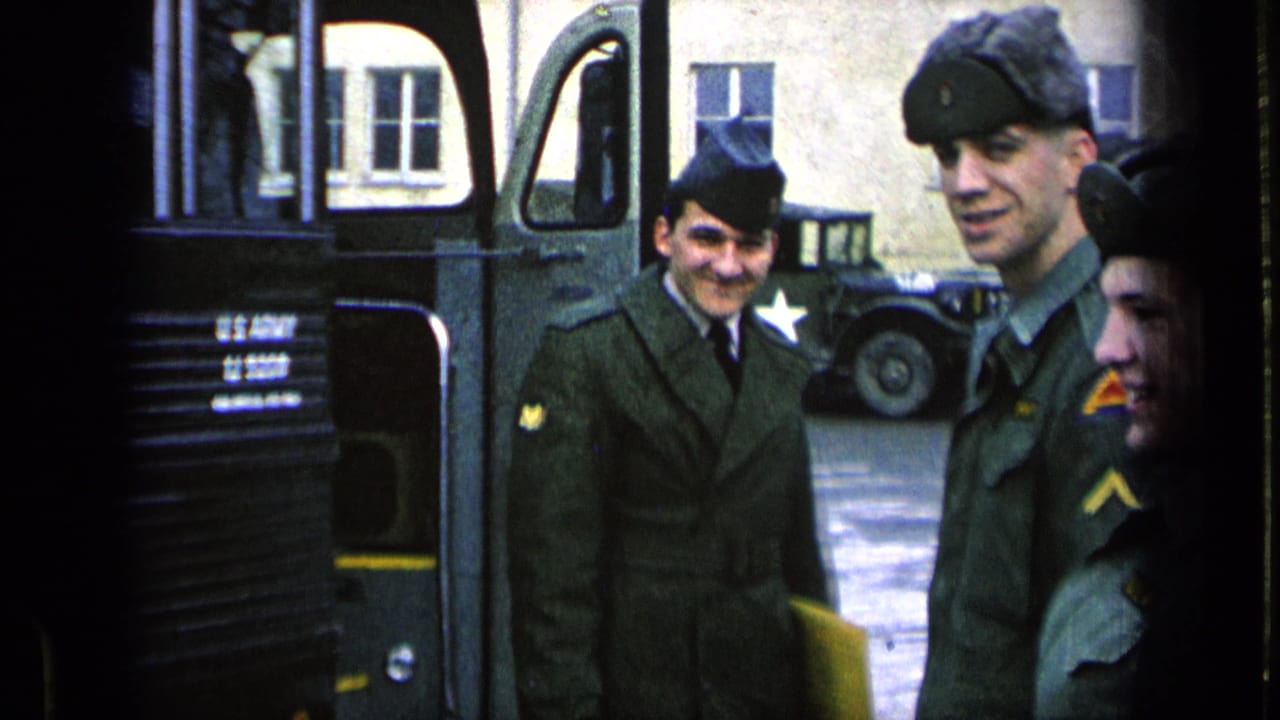 On a Germany military base in 1963, U.S. Army soldiers stand near a bus while another star-marked vehicle is parked behind them.