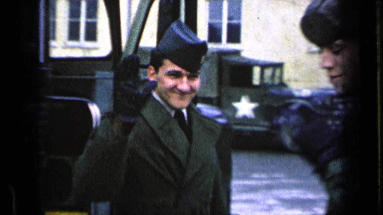 A smiling soldier waves beside a bus while another soldier is partly visible at the edge.