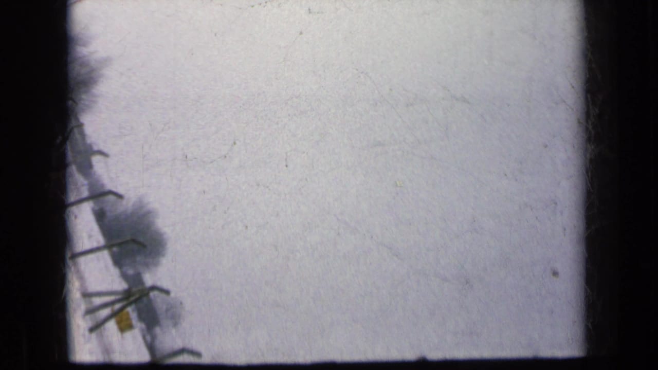 Pale overexposed frame with a dark vertical object at the edge.