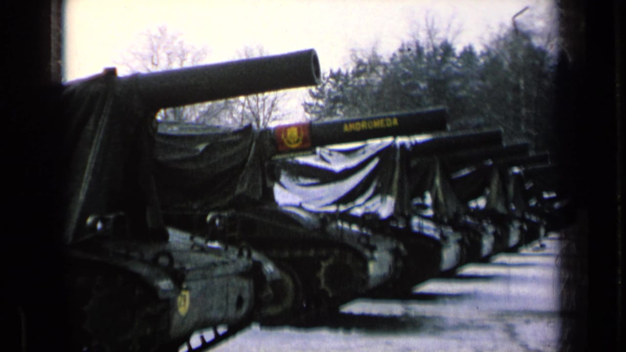 Covered tanks lined up outdoors, one barrel marked ANDROMEDA.