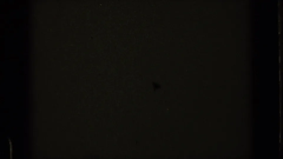 The final contact-sheet frame is mostly dark, with slight film texture and edge markings visible from the 8mm scan.