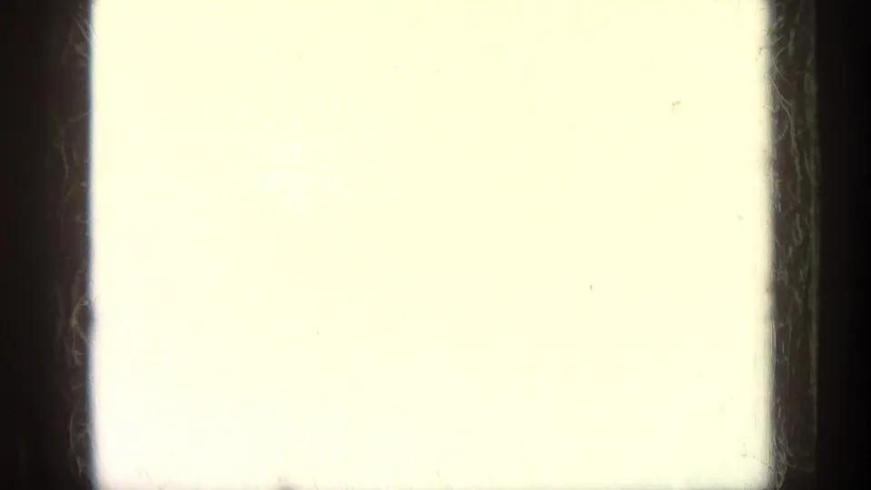 The frame is largely overexposed, showing pale film area, dark gate edges and minimal recoverable scene detail.