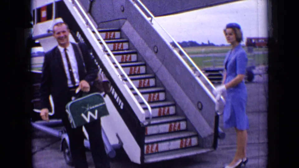 The 1963 London airport scene shows a suited man holding a briefcase beside BEA stairs, with a flight attendant waiting nearby.