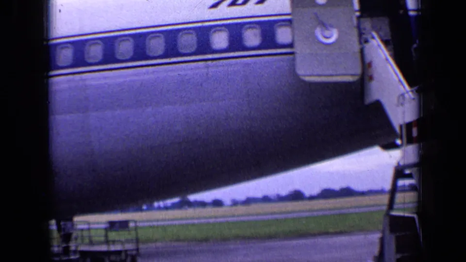 The closing frame emphasizes the Boeing 707 fuselage, cabin windows, blue stripe, and mobile stairway on the London airport tarmac.
