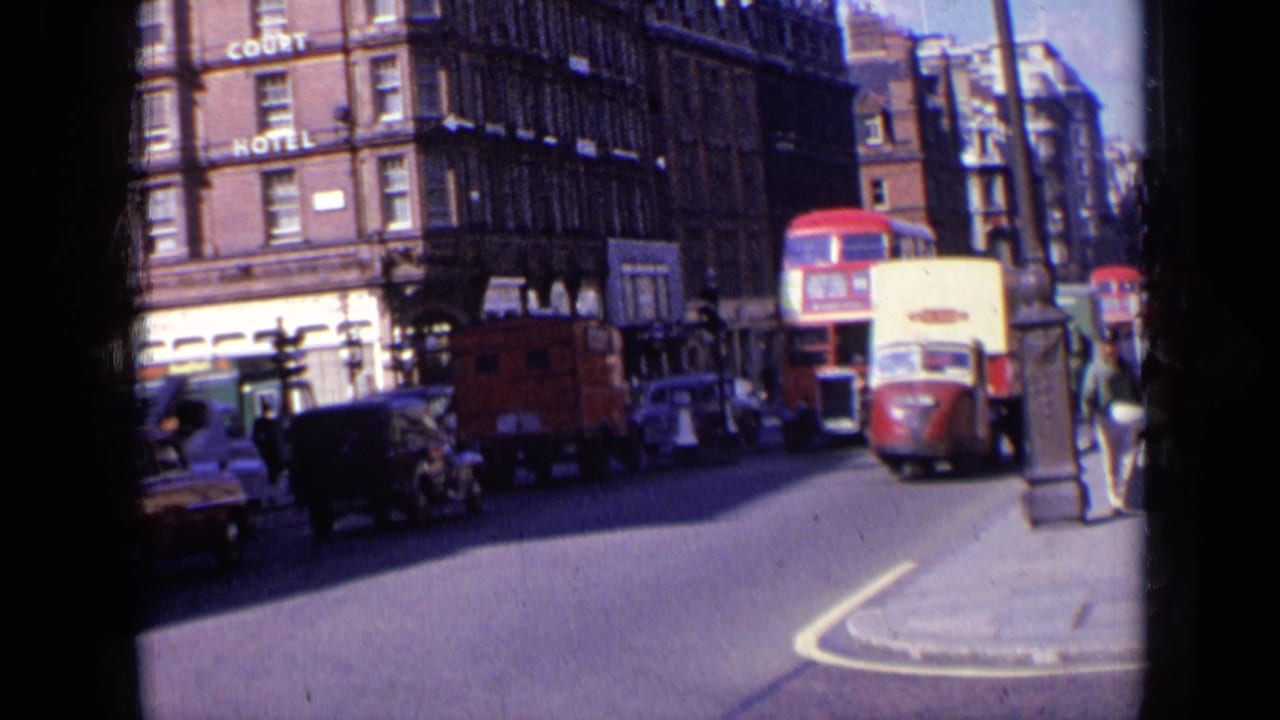 London street traffic with a red double-decker bus, cars, delivery vehicles, and Court Hotel signage.