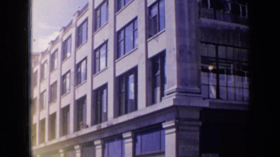 The final frame shows a bright 1963 London street view of a building corner with large windows and classical columns.