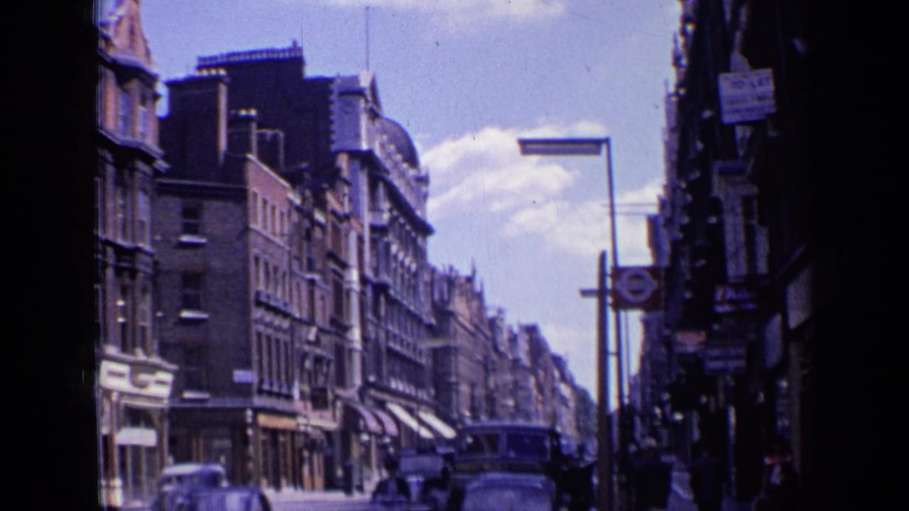 Busy London street with an Underground roundel, cars, pedestrians, and shop signs.