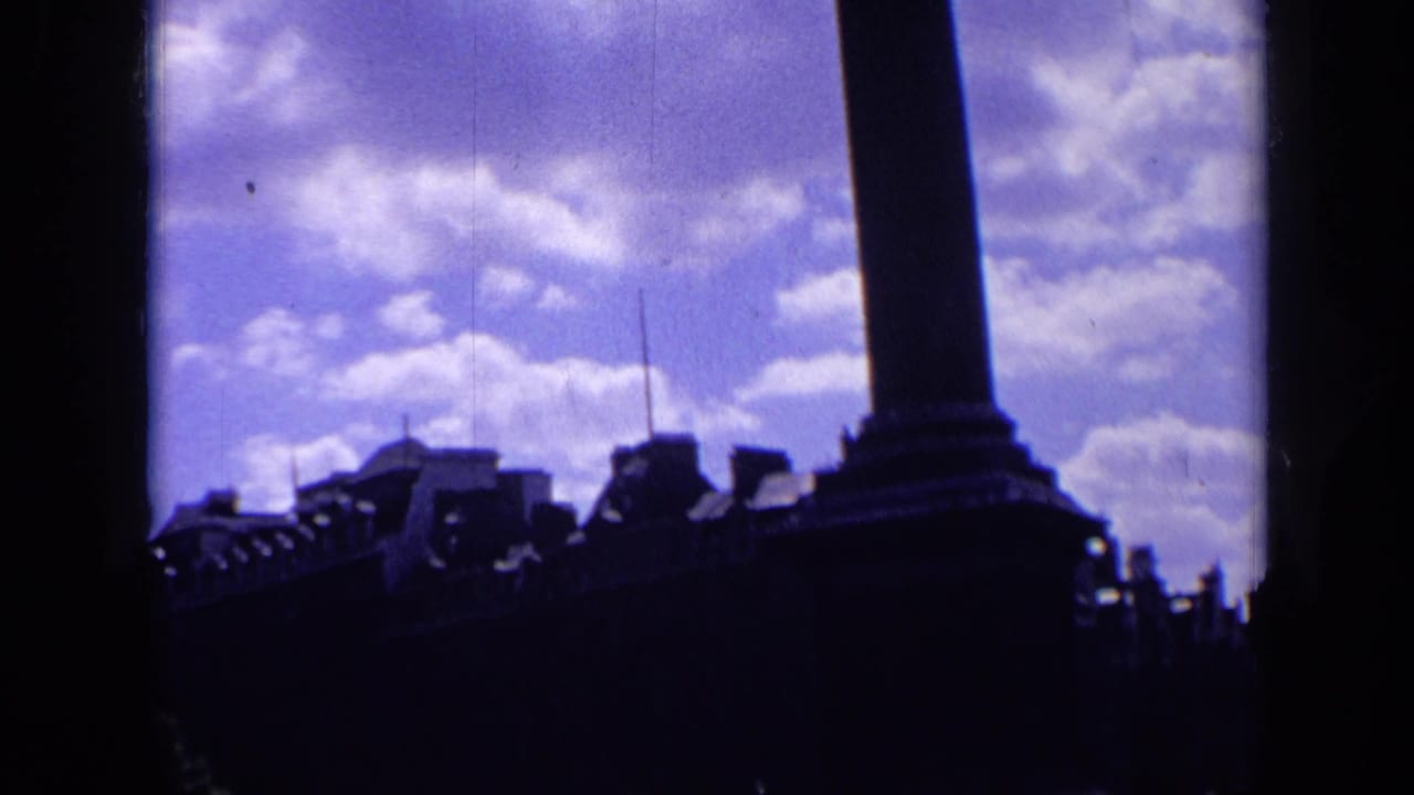 Silhouetted column base and city roofline beneath a purple cloudy sky.