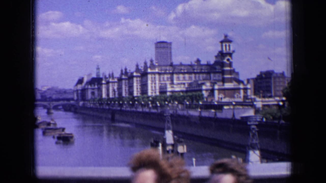 Riverside building and river view partly interrupted by people at the lower edge.