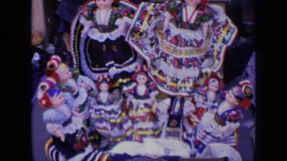 1963 Russia home-movie close-up of colorful traditional-looking dolls arranged for sale on a street display.