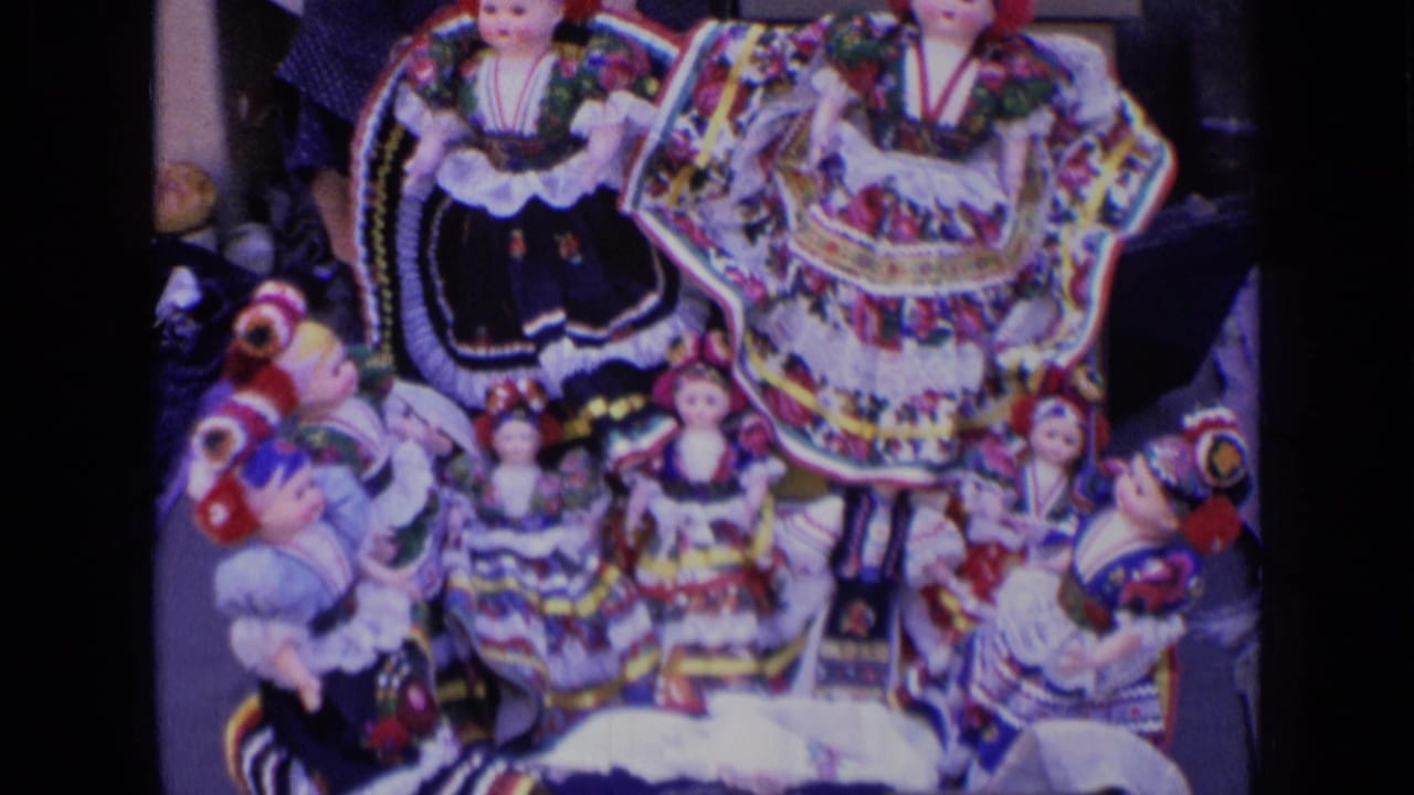 Cluster of colorful traditional dolls in layered folk costumes.