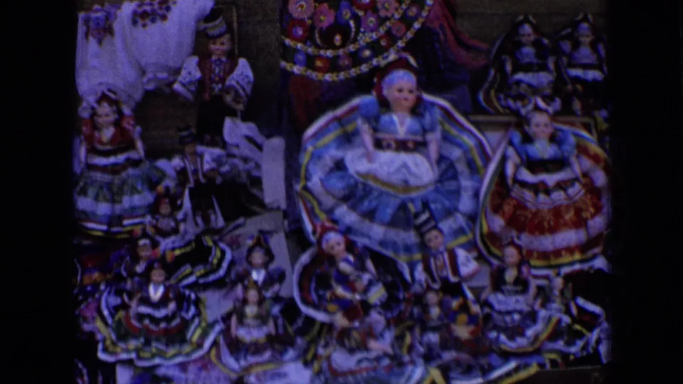 1963 Russia 8mm frame showing a lower section of the doll display, with large skirted dolls surrounded by smaller figures.