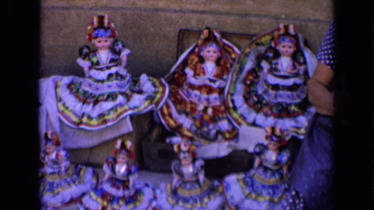 A street display of handmade dolls in Russia, 1963, with a vendor partly visible at the right edge.