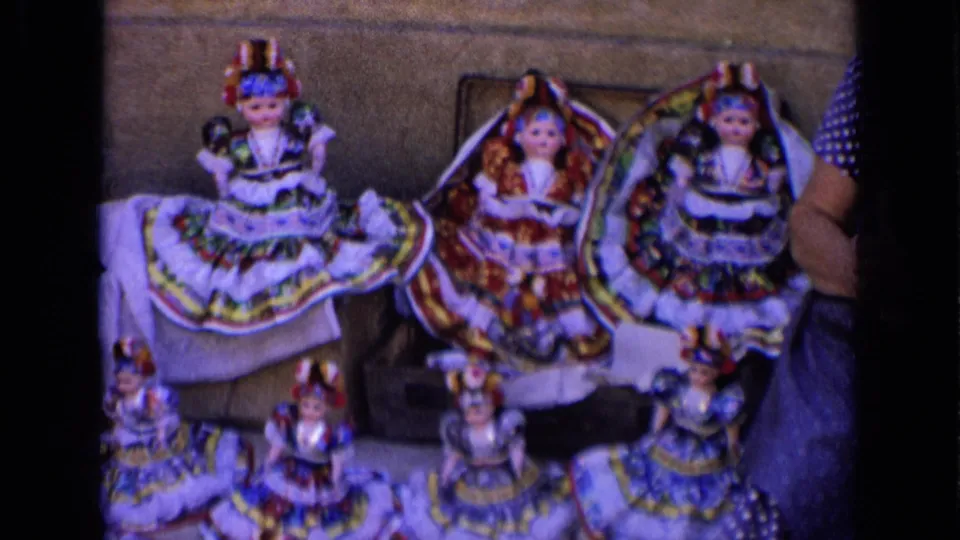 A street display of handmade dolls in Russia, 1963, with a vendor partly visible at the right edge.