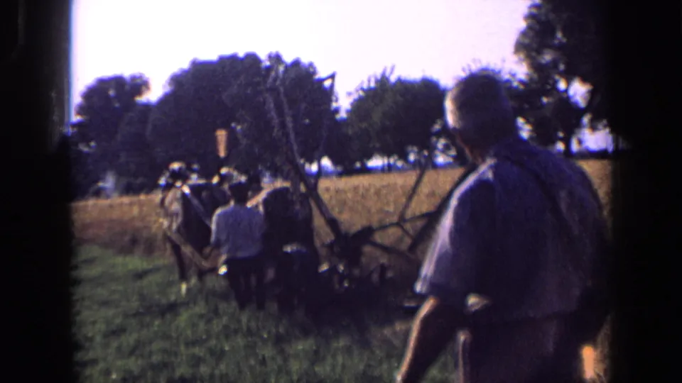 In the 1963 Russia home-movie footage, a man stands in the foreground while the horse-drawn plow team moves away.