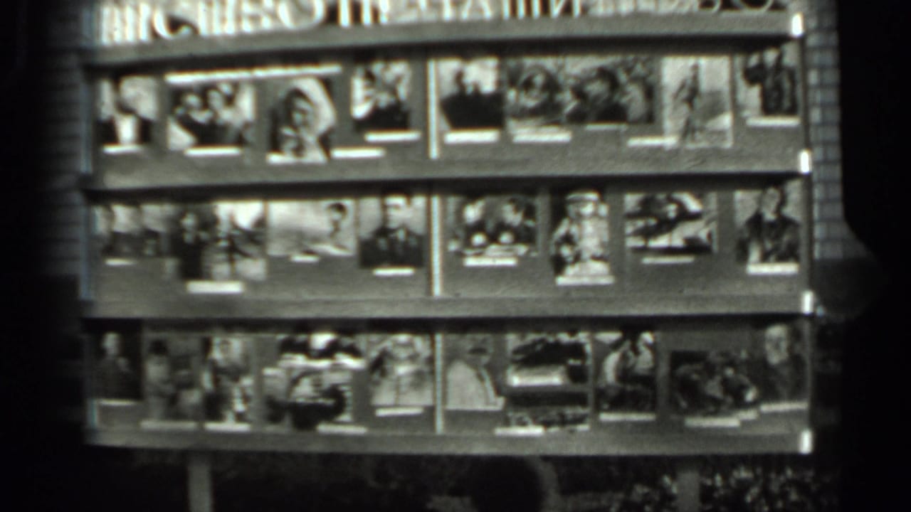 1963 Russia 8mm frame showing a public magazine or photo display with Cyrillic signage and several rows of small printed images.