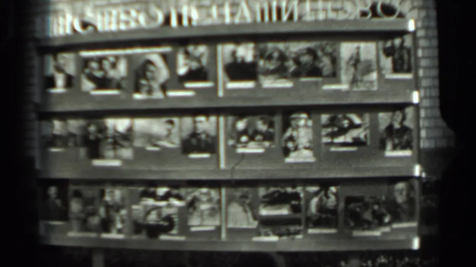 1963 Russia black-and-white frame of a Cyrillic public magazine or photo stand, with the display filling most of the view.