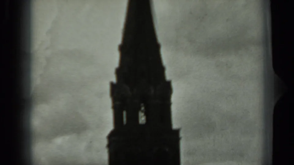 1963 Russia 8mm frame showing a pointed tower spire and upper structure from a low visitor-shot angle.