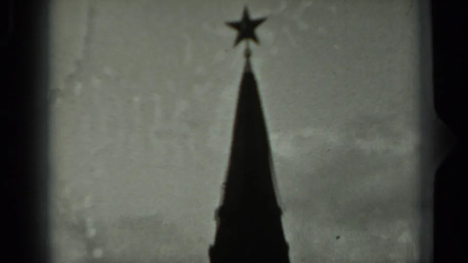1963 Russia 8mm frame of a pointed tower spire topped by a star, silhouetted against an overcast sky.