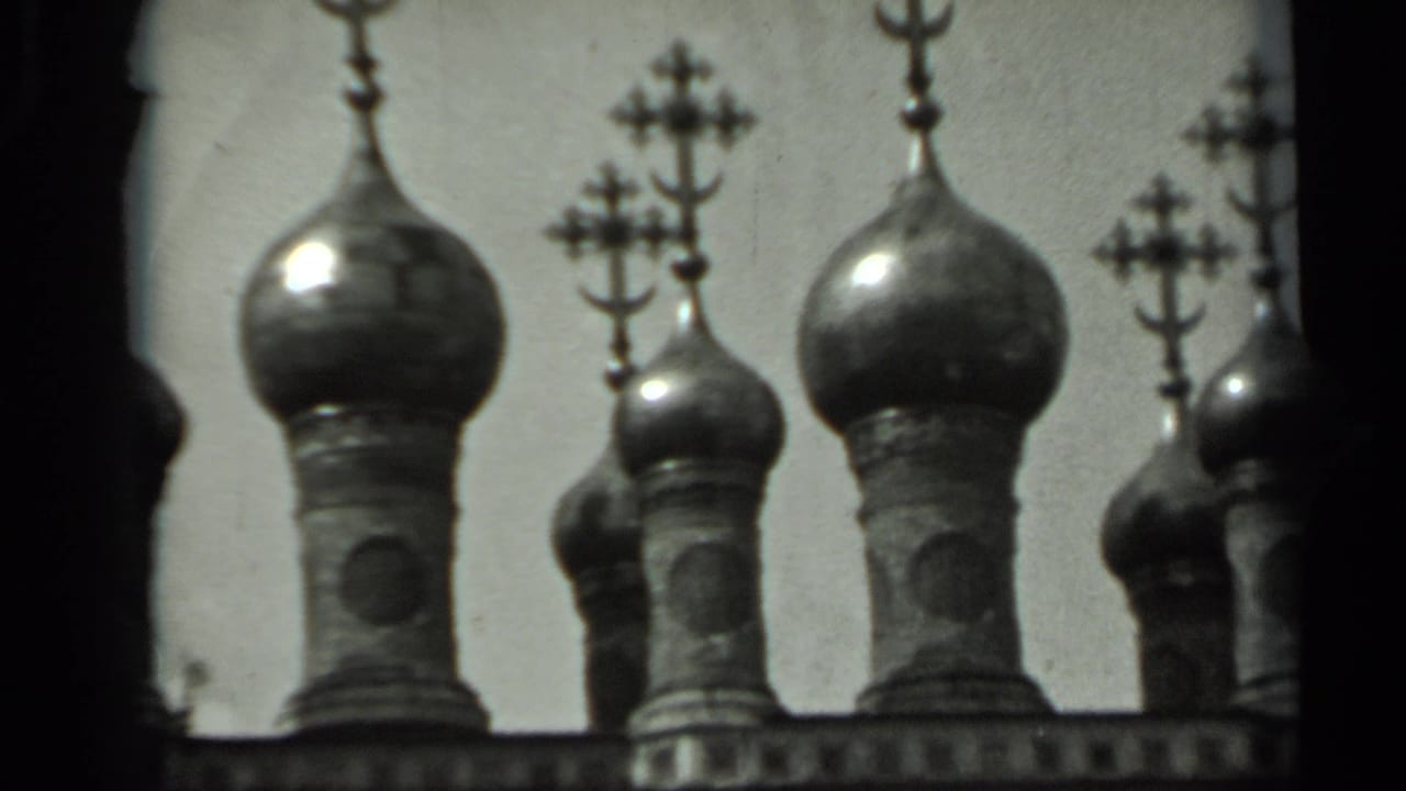 1963 Russia 8mm frame showing Russian Orthodox onion domes and crosses seen through dark foreground framing.