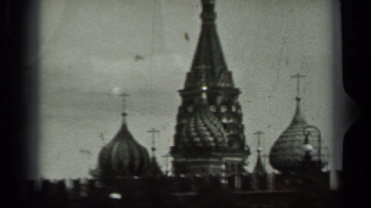 Patterned cathedral tower and rounded domes seen through dark film edges.