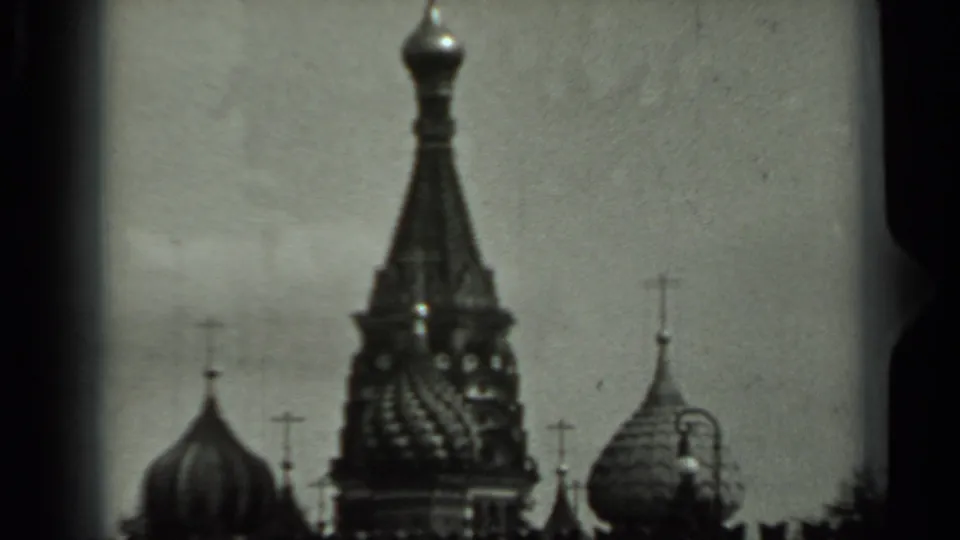 1963 Russia 8mm frame with onion domes and religious roof crosses visible against a pale sky.