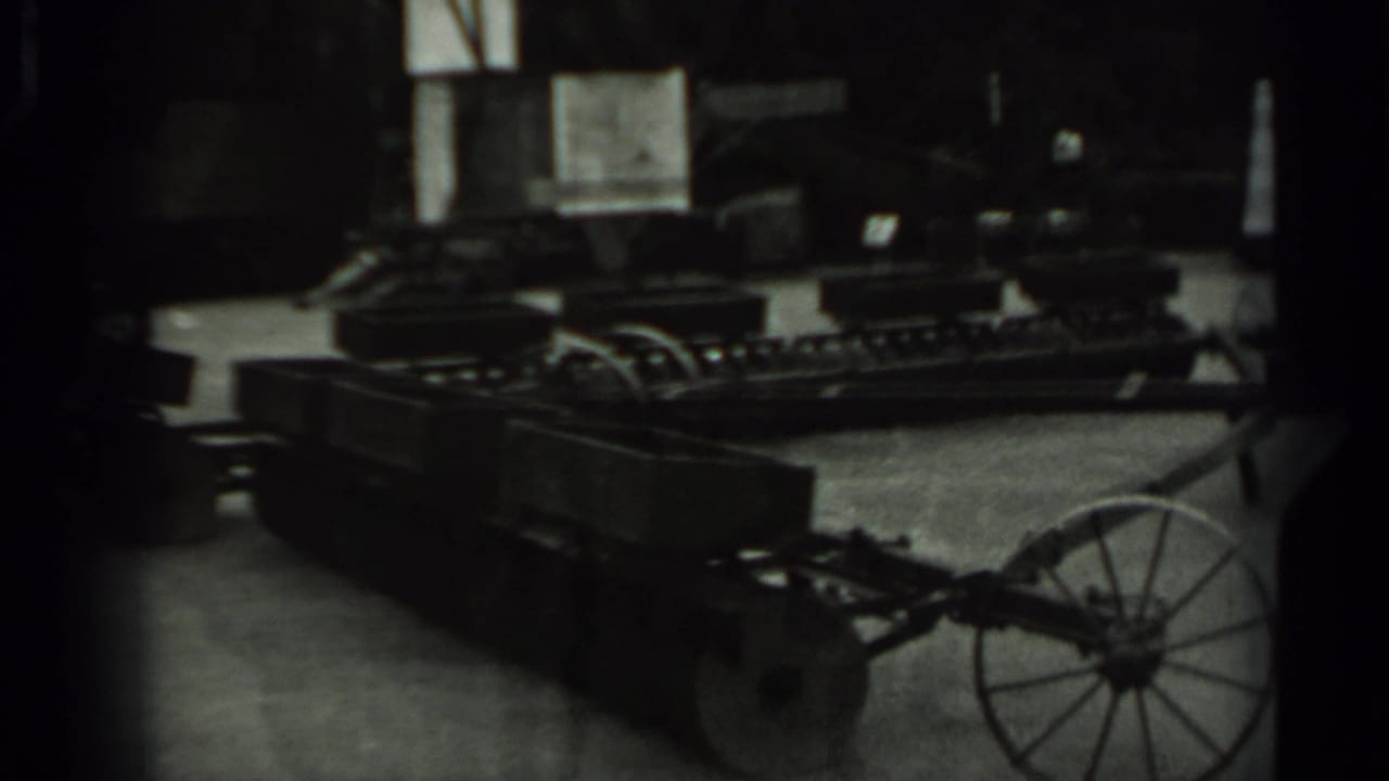 1963 Russia 8mm frame with a dimly seen wheeled machine or cart-like equipment, partially obscured by dark exposure and film borders.