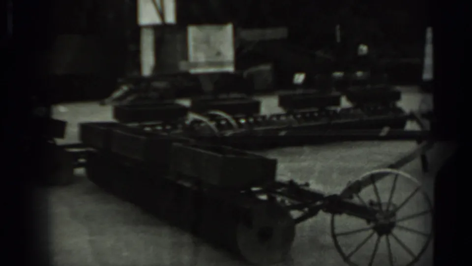 1963 Russia 8mm frame with a dimly seen wheeled machine or cart-like equipment, partially obscured by dark exposure and film borders.