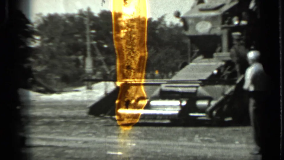 1963 Russia 8mm frame showing a large farm machine in a bright outdoor yard with a worker near its side.