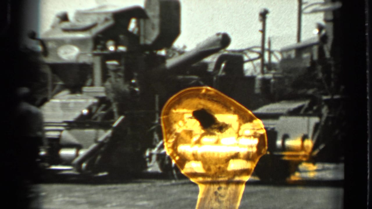 1963 Russia 8mm frame with a closer view of heavy farm machinery and a worker partly obscured beside it.