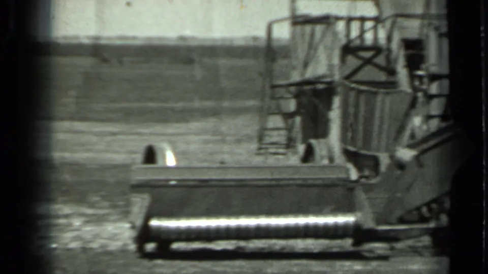 1963 Russia 8mm frame showing a large tracked vehicle or equipment platform in an open rural field.