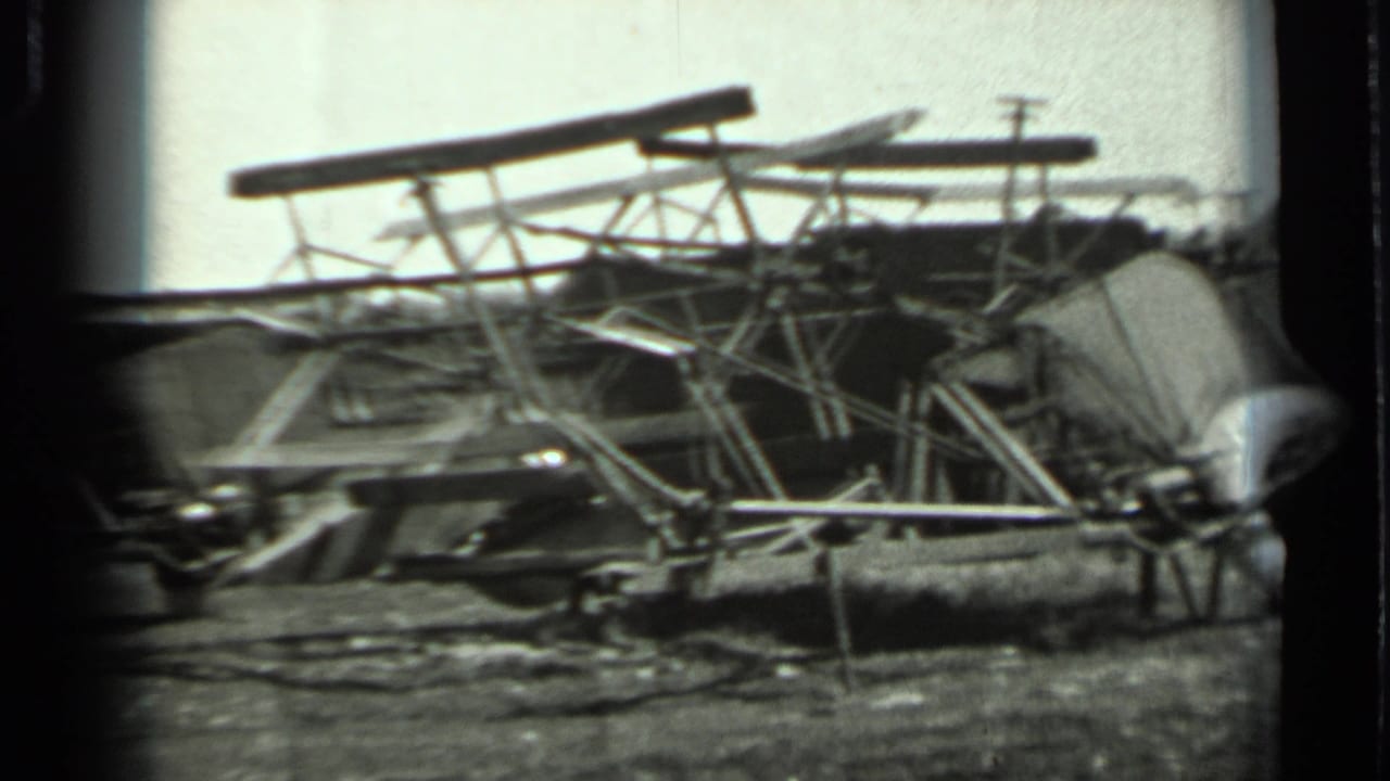 1963 Russia 8mm frame with tangled metal frames, long beams, and scattered parts in an outdoor field setting.