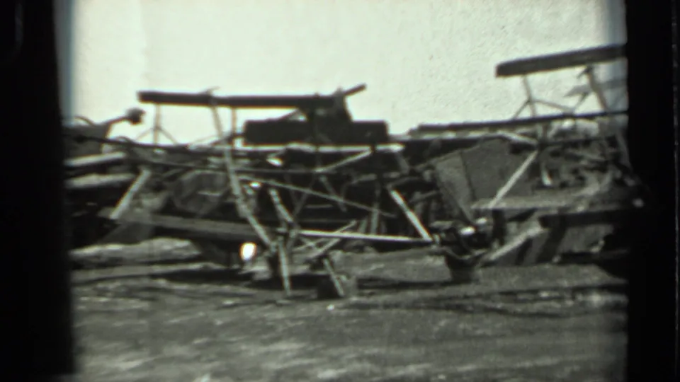 1963 Russia 8mm frame showing weathered metal framework, supports, and equipment-like parts across rough ground.