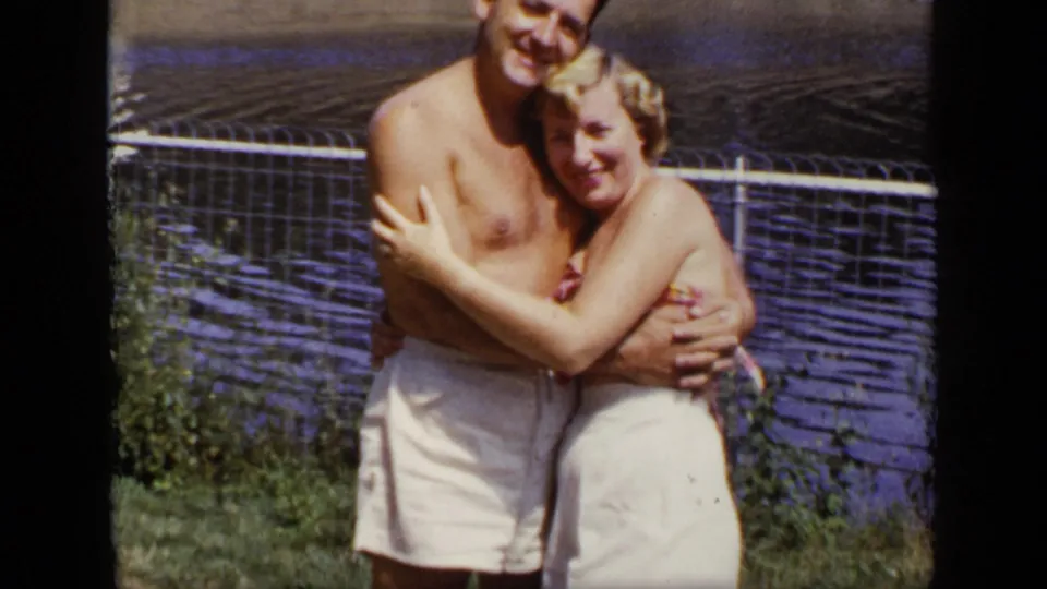 The final frame shows the couple still embracing near lake water, with the man partly cropped by the 8mm frame edge.