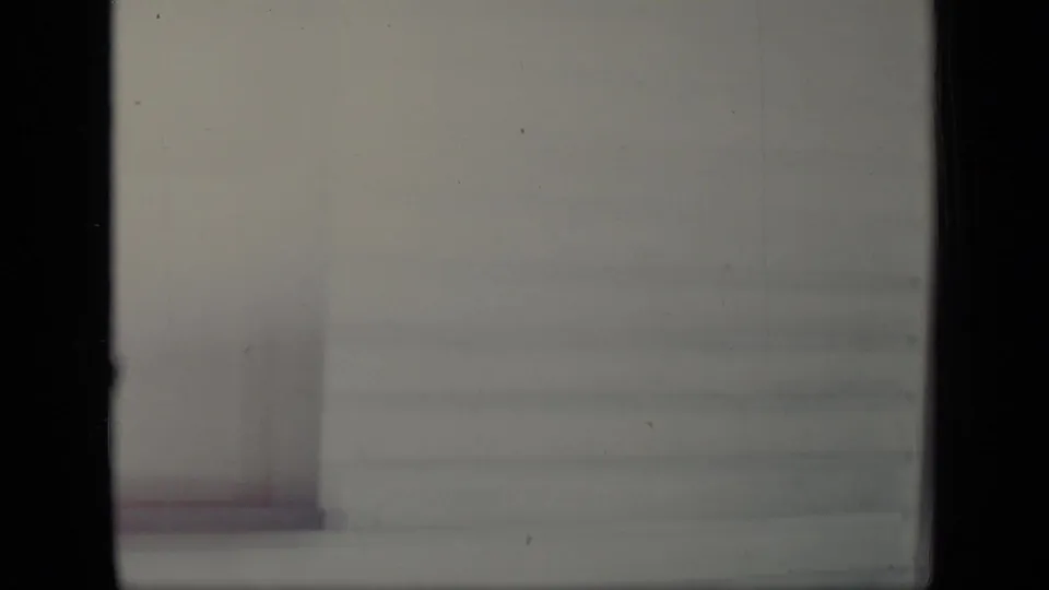 The final frame is a blurred, pale view of the house exterior, with siding and a vertical doorway or wall edge barely defined.