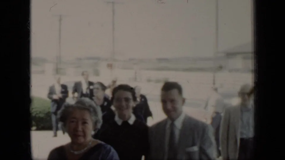 A small group of well-dressed adults smiles toward the camera in 1948 New York home-movie footage.