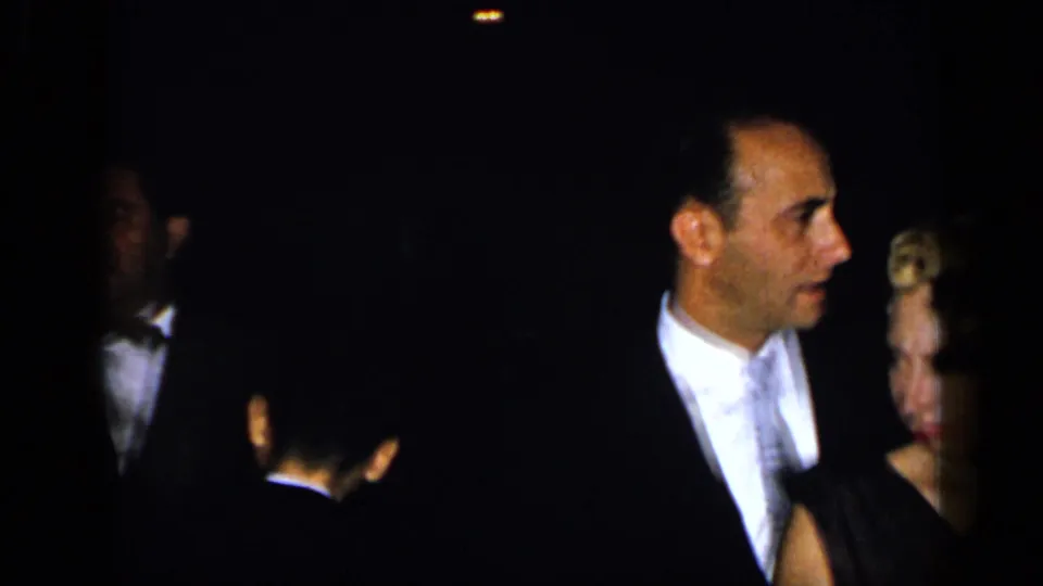 Tuxedoed men and nearby guests appear in a dim New York formal gathering captured on 8mm film in 1948.