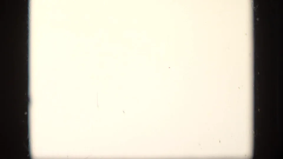 Overexposed 8mm frame from the 1948 New York clip, showing a pale blank area with dark film borders and slight dust marks.