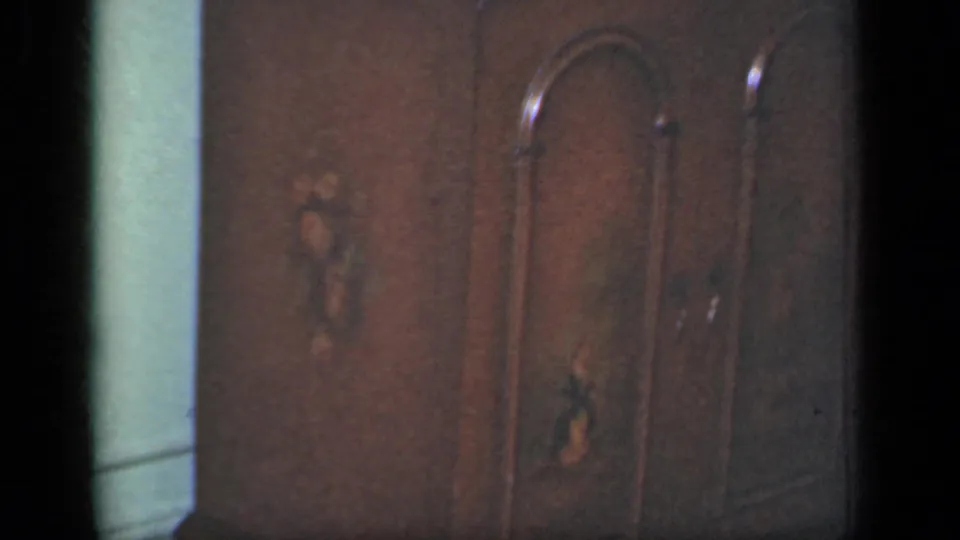 Dark wardrobe doors with arched paneling and small decorative inlays fill the 1949 New York interior frame.