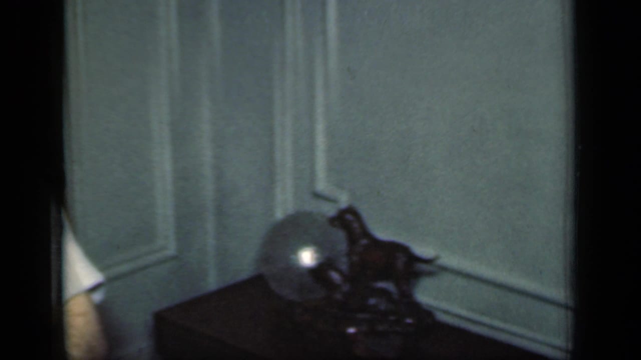 Paneled interior wall with a small table and decorative object.
