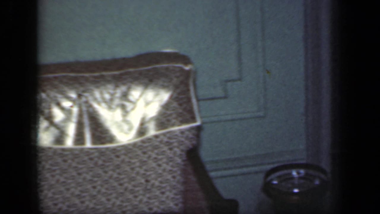 A dim frame with a partial interior or pond-side structure and film gate edges.