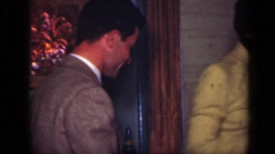 In the final 1949 New York frame, the suited man turns near a doorway as the woman in yellow appears partly at the edge.