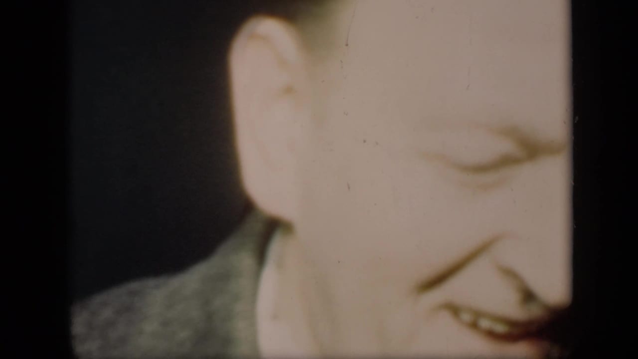 Extreme close-up of an adult man's face in soft focus.