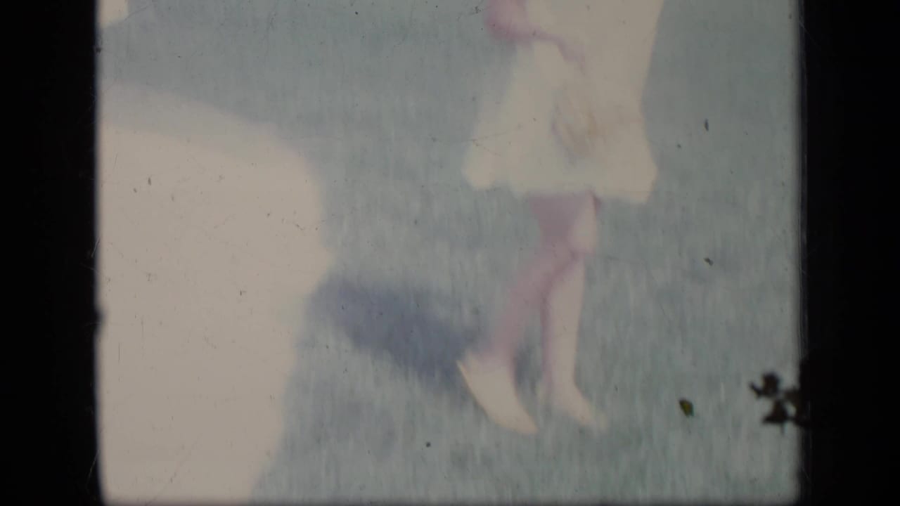 Overexposed view of the woman’s lower body and shadow on grass.