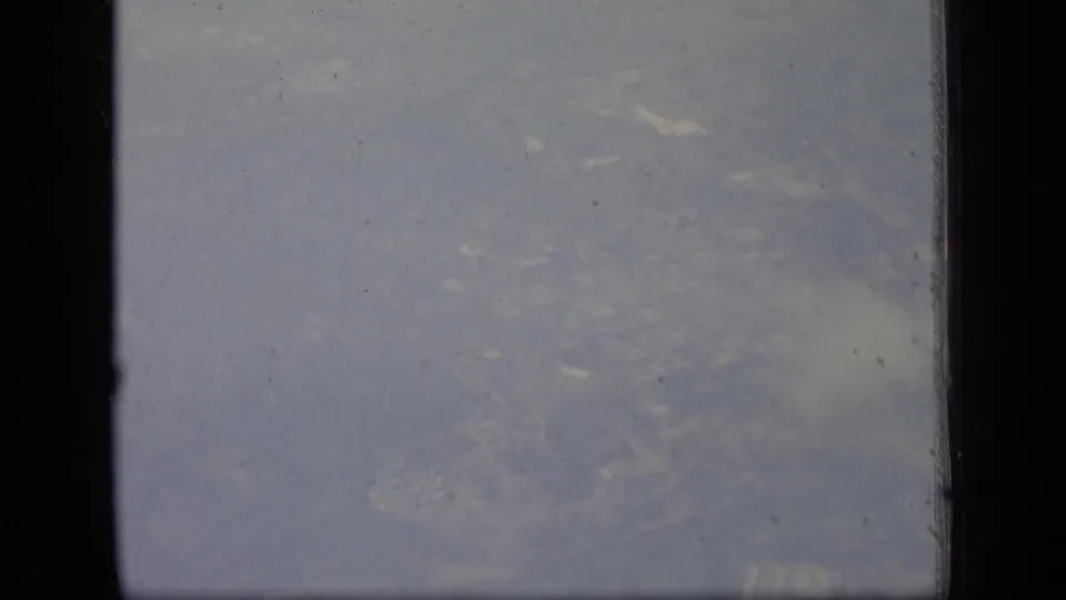 New Jersey village terrain appears below the airplane window in this 1970 8mm aerial frame.
