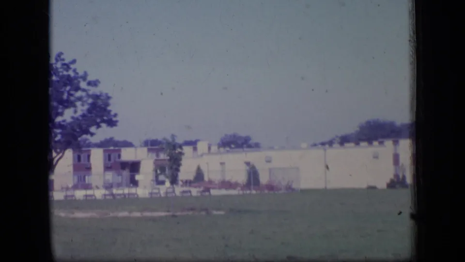 1970 New Jersey exterior view of low-rise apartments, a lawn, trees, and balconies in soft 8mm color.